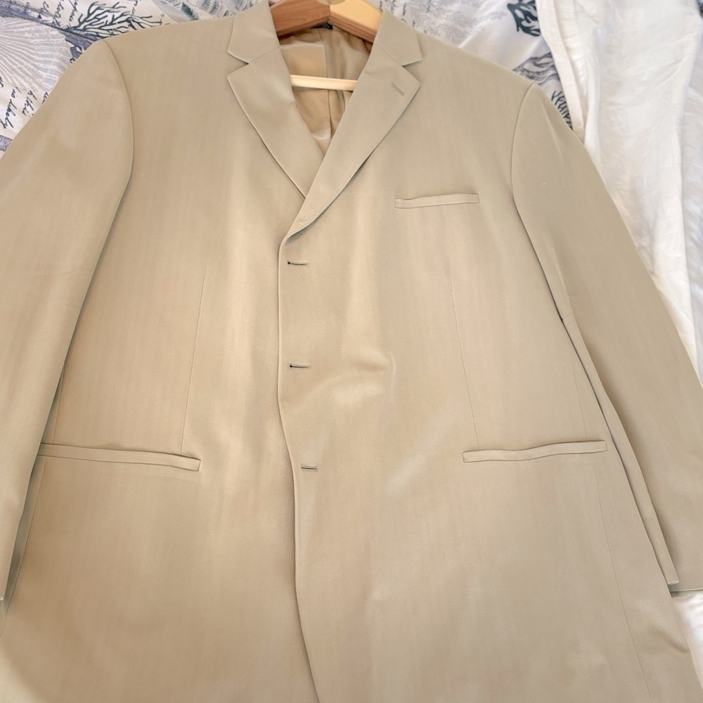 Suit, rich cream color that would make look good any man who wears it.